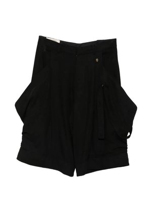 Брюки с объемными карманами и драпировкой
